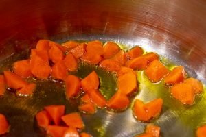 Carrots releasing beta carotene to the coconut oil