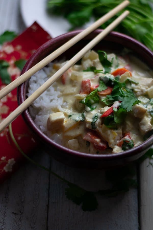 Thai Mahi Mahi Green Coconut Curry in red bowl with chopsticks and red napkin 