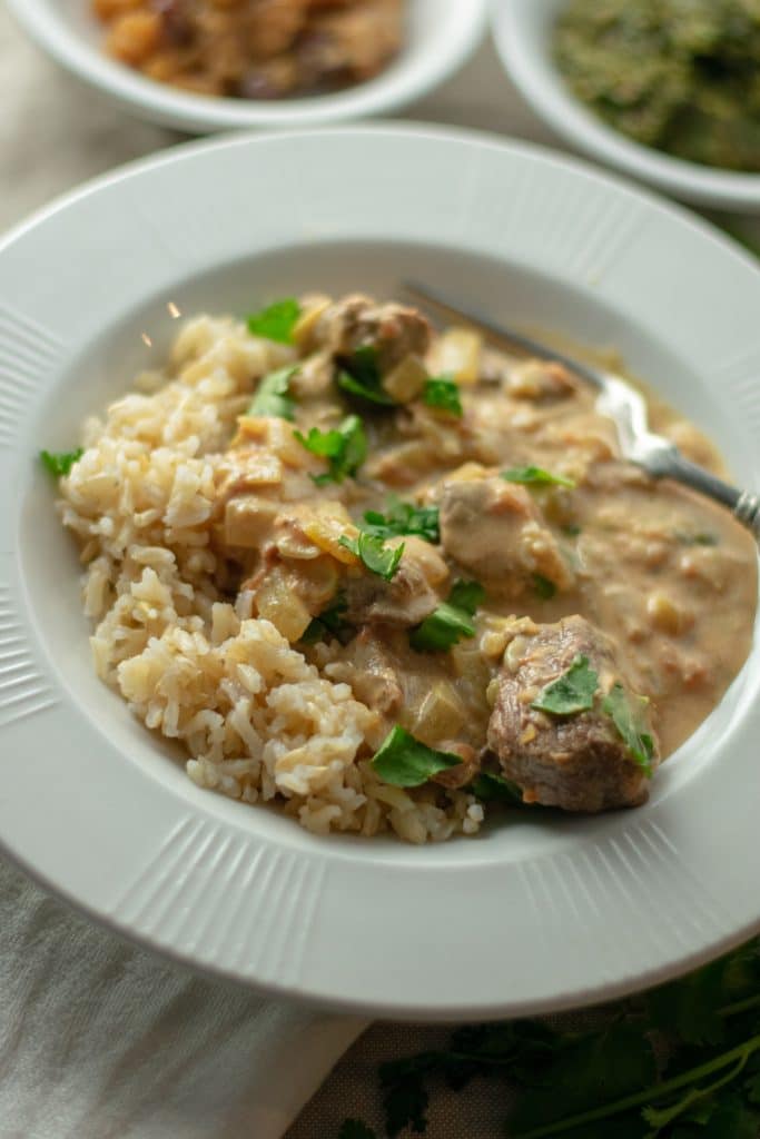 Beef Coconut Mik Curry in bowl with condiments