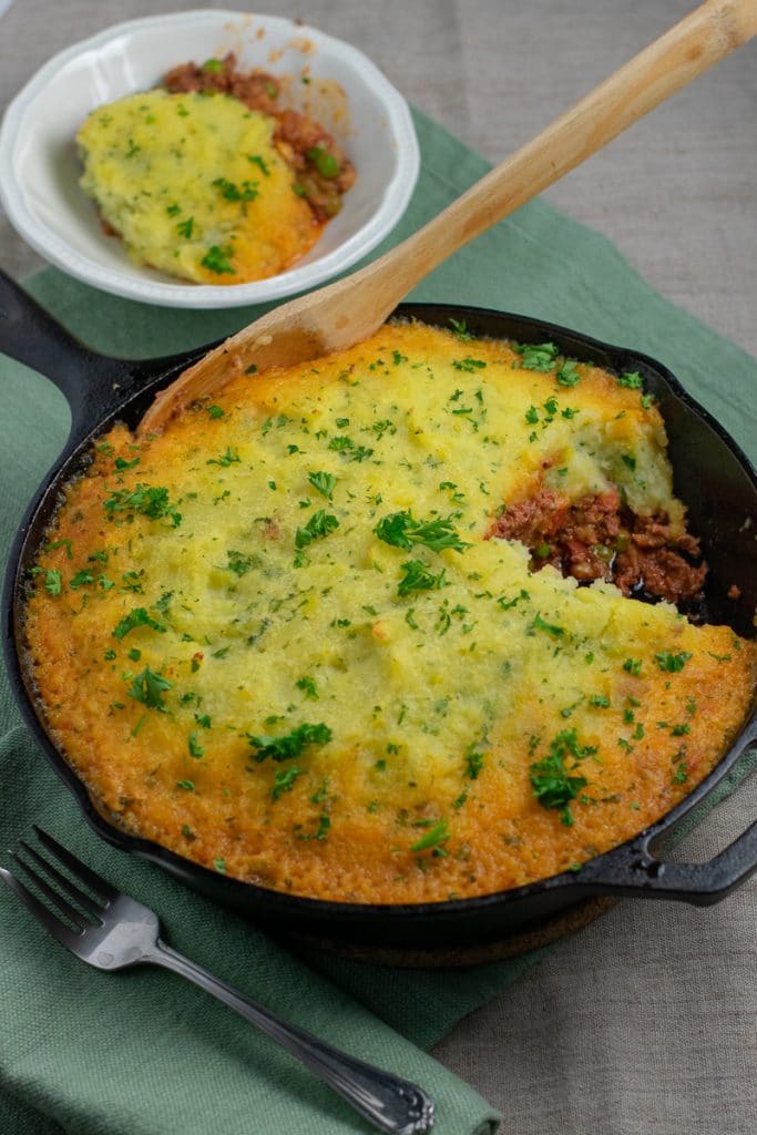 Beef Shepherd's Pie in cast iron skillet partly served