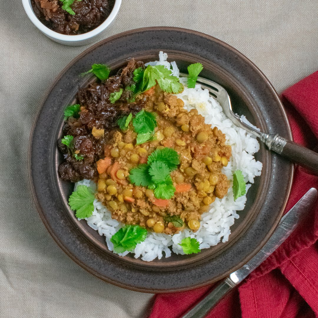 Spiced Lentils with Beef in brown bowl with raisin chutney