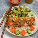 baked miso salmon fillet on white rice with salad on white plate