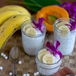 coconut milk tapioca pudding in glass jars garnished with bananas and orchids