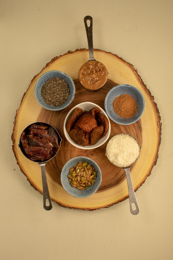 ingredients for raw date-apricot almond butter bites on wooden board