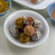 raw date-apricot almond butter bites in white dish