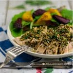 Garlic-Fennel-Rosemary Baked Chicken on white plate with fork