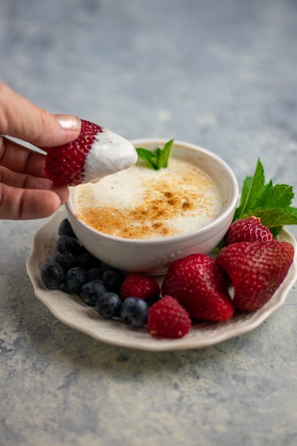 spiced yogurt dip in white bowl with fruit
