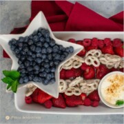 patriotic fruit tray with spiced yogurt dip in white bowl