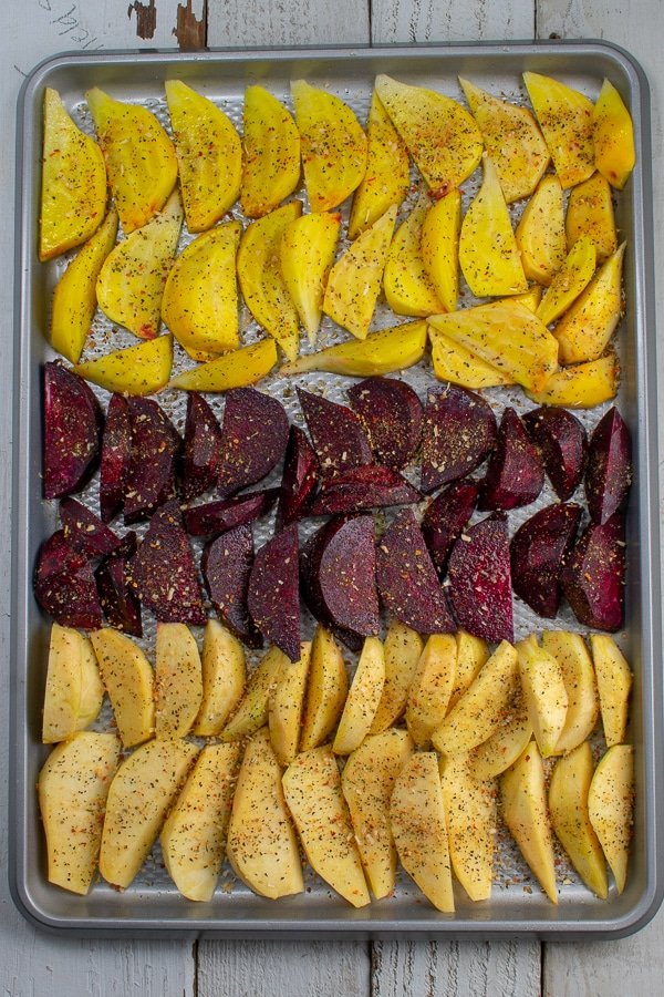 rutabagas and beets sliced in wedges on sheet pan