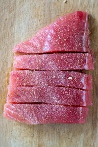 opah fillet sliced and seasoned on bamboo board