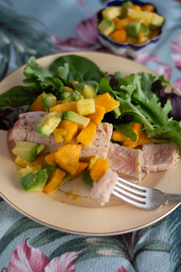 seared opah with papaya salsa on china plate and hawaiian napkin