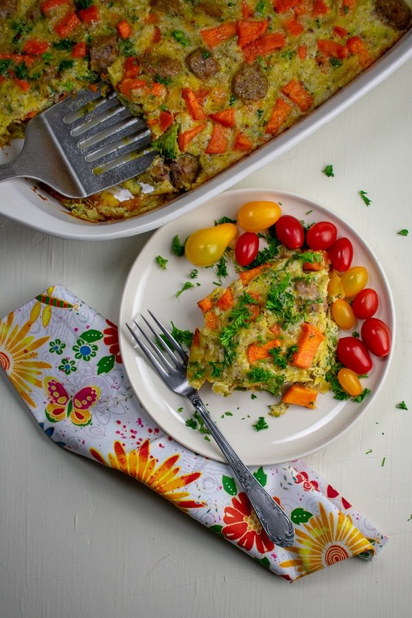 sweet potato sausage broccoli breakfast bake on white plate overhead view