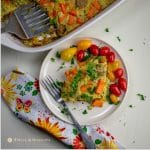 sweet potato sausage broccoli breakfast casserole served on white plate with fork and nakin==