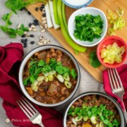 Inst image of two bean chili in two bowls with red napkin