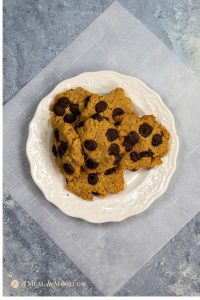 almond flour dark chocolate chip cookies on white plate overhead view