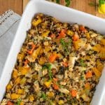 butternut squash chicken rice bake in white baking dish on white napkin