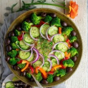 delicious mediterranean quinoa salad in large bowl with flowers