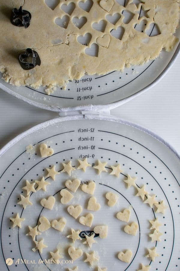 stars and hearts cut from gluten-free pie crust on pastry mat