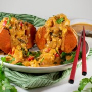 square image of thai massaman curry stuffed sweet potato on white plate