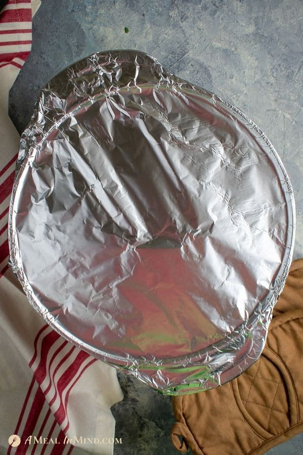old fashioned oven baked beef stew in dutch oven covered with foil