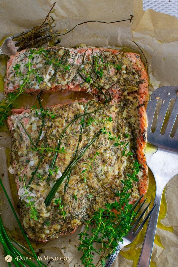 aromatic garlic herb salmon baked in parchment overhead view after baking