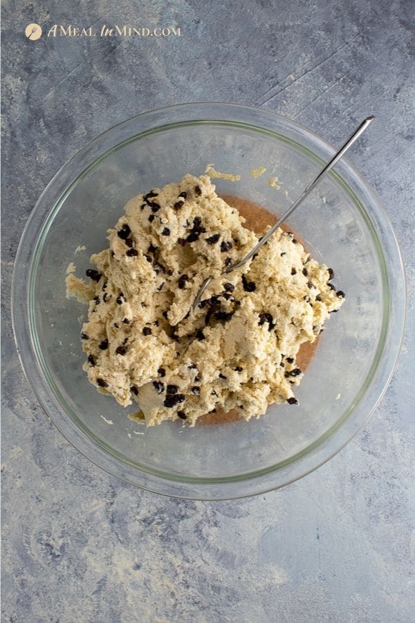 savory millet-currant biscuits dough in glass bowl