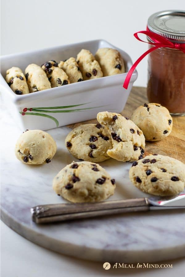 savory millet-currant biscuits on cutting board with apple butter