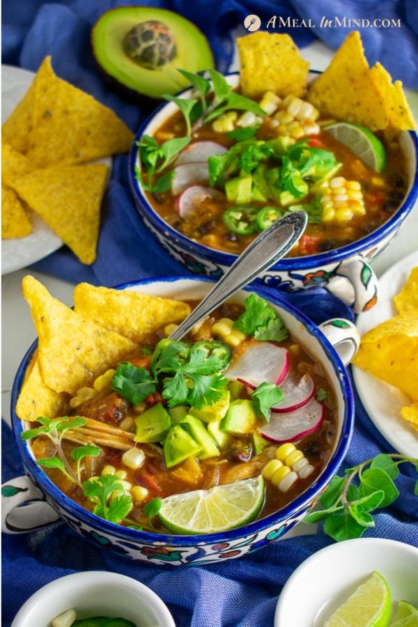 savory roasted hatch green chile tortilla soup in patterned bowls