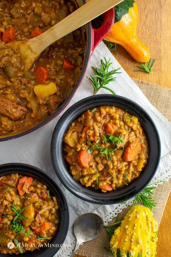 easy beef barley pumpkin stew in black bowls