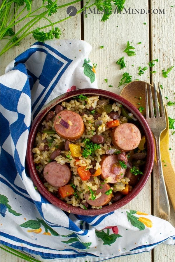 dirty rice vegetable sausage bake overhead view in red bowl