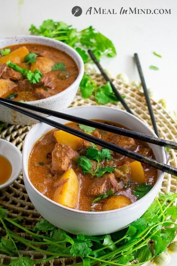 thai massaman curry with beef and potatoes in bowls