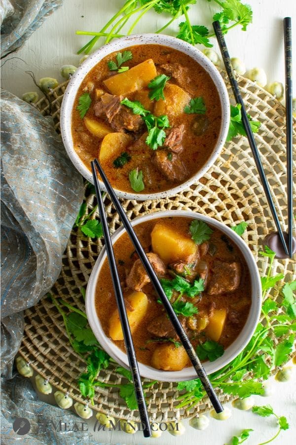 thai massaman curry with beef and potatoes in bowls