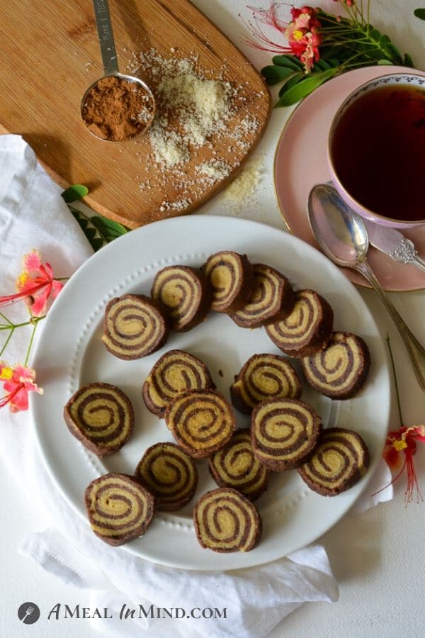 Almond Flour Carob Pinwheel Cookies from overhead with a cup of tea