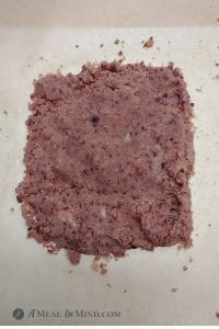 pink dough for cranberry almond-flour pinwheel cookies on parchment paper