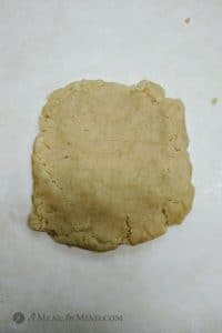 cranberry almond-flour pinwheel cookie dough on parchment paper