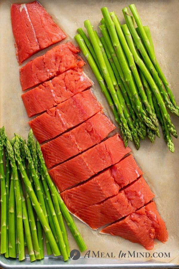 Pecan Mustard Salmon with Asparagus sliced on baking sheet