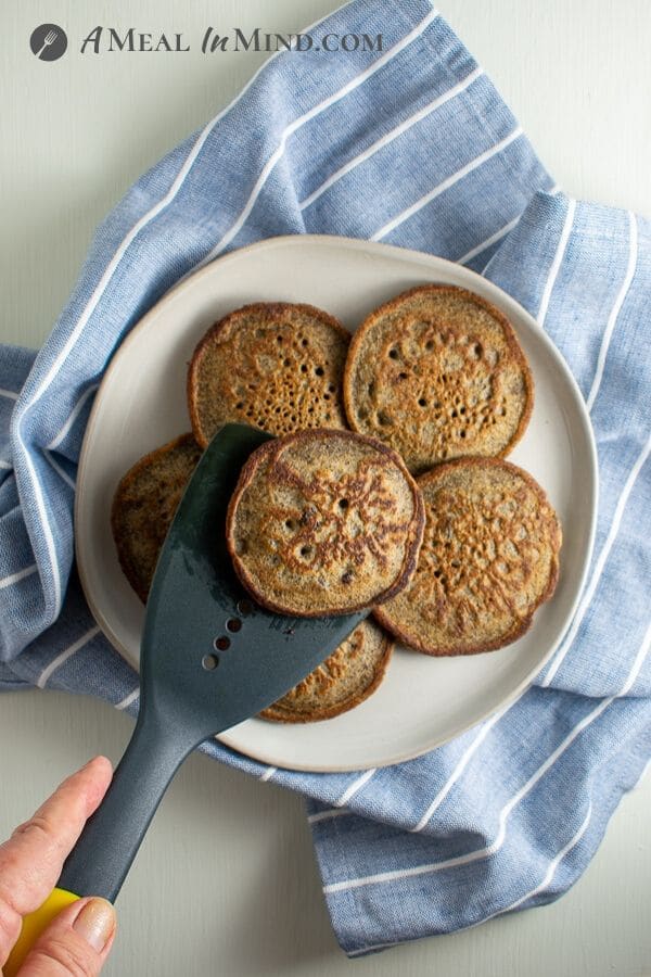 Buckwheat-Currant Pancakes Gluten Free on plate with spatula