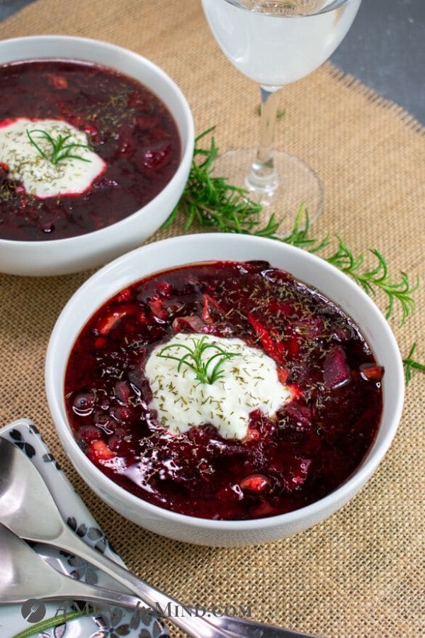 Beet-Cabbage Borscht Soup side view in white bowls with yogurt topping