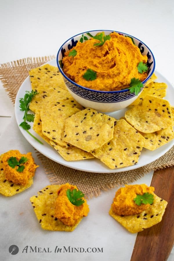 Moroccan Roasted-Carrot Hummus with chips on white plate