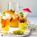 Peach-Ginger Limeade Mocktail in tall glasses with pitcher