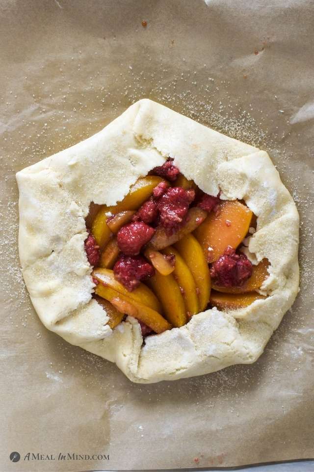 Gluten-Free Plumcot-Raspberry Galette ready to bake on parchment