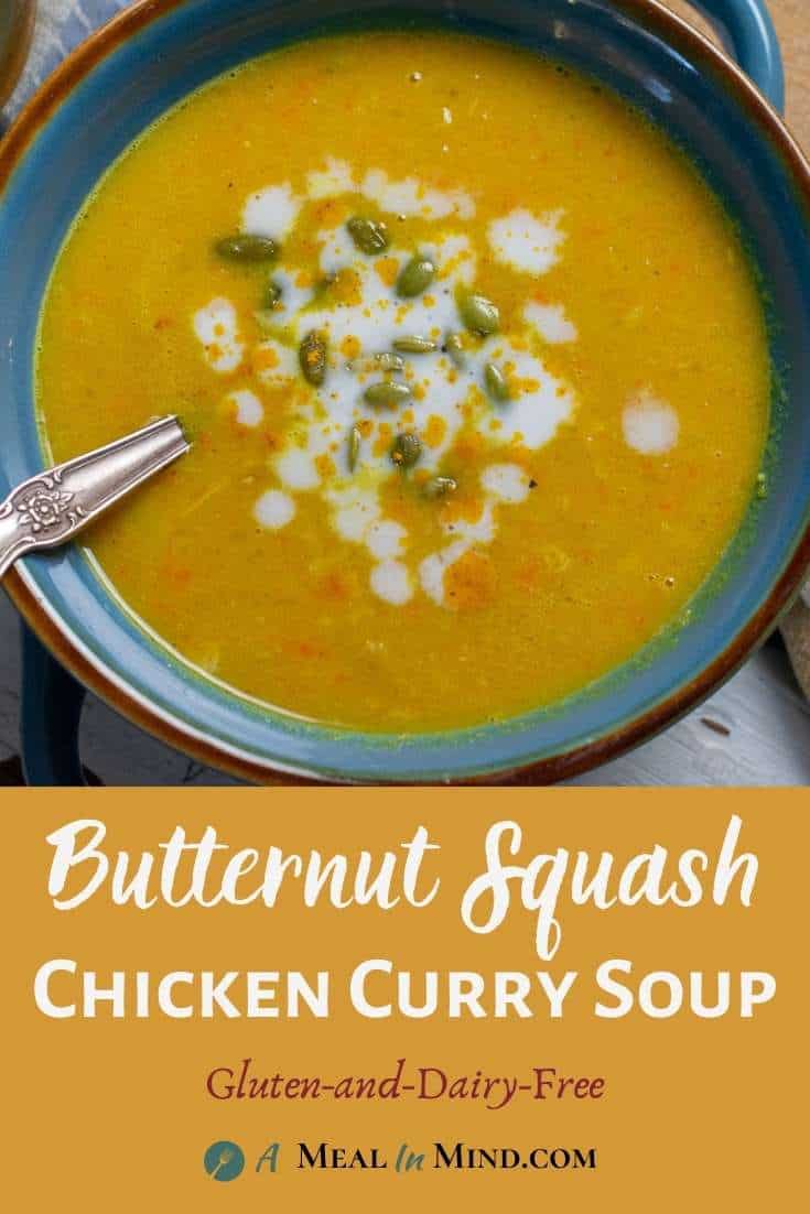 Butternut squash chicken curry soup in blue bowl with spoon