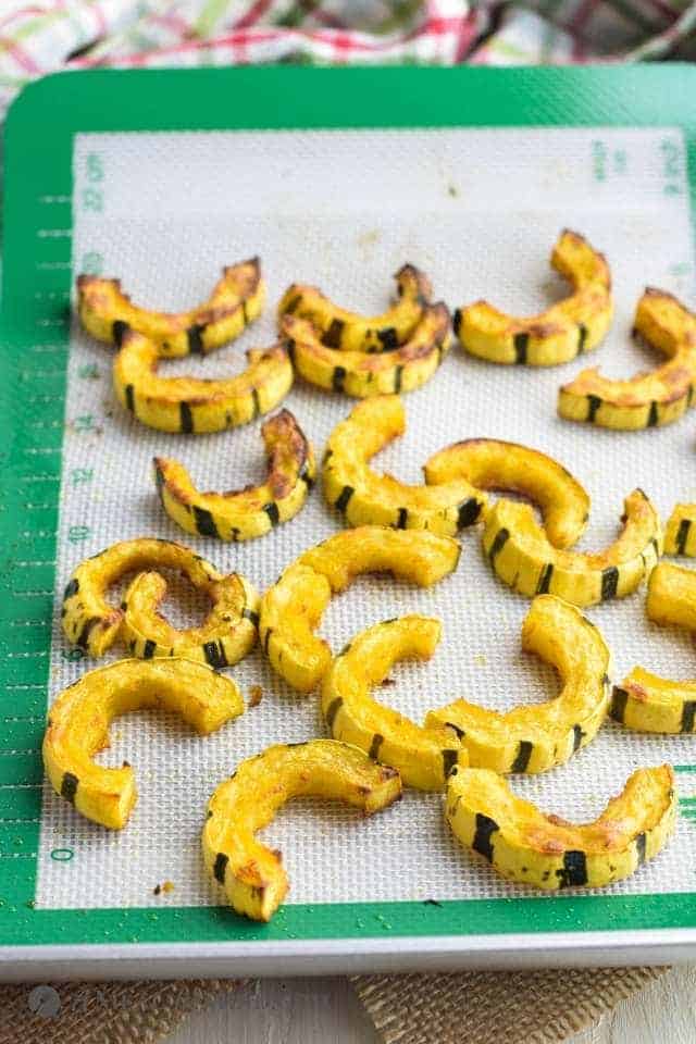 delicata squash slices roasted on silpat on baking tray