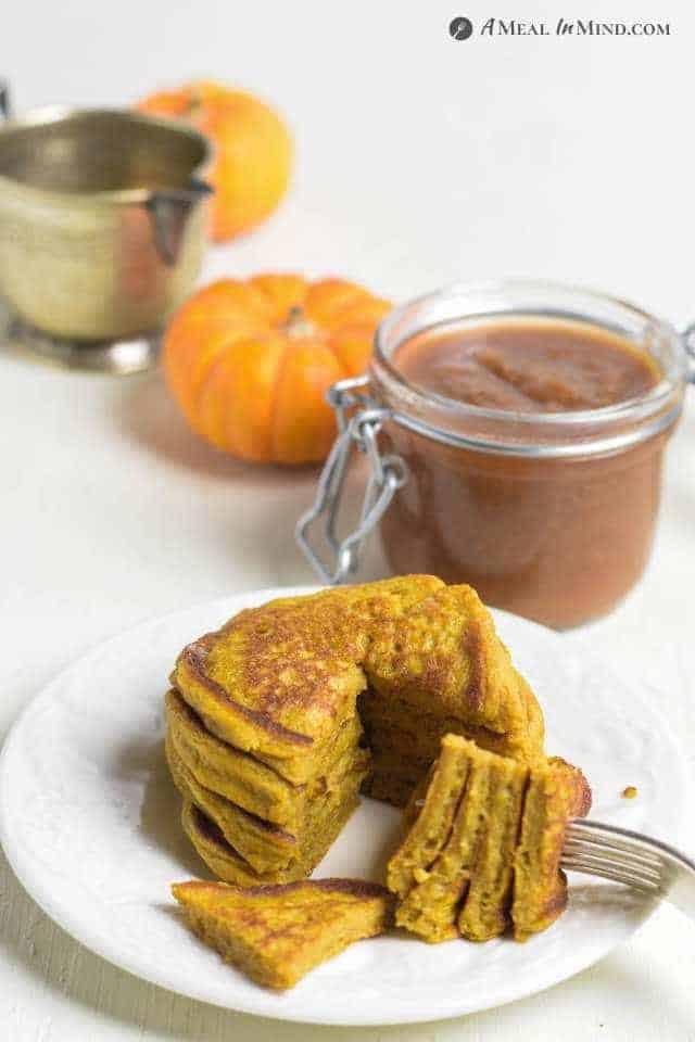 Pumpkin Protein Pancakes on white plate with apple pluot butter behind