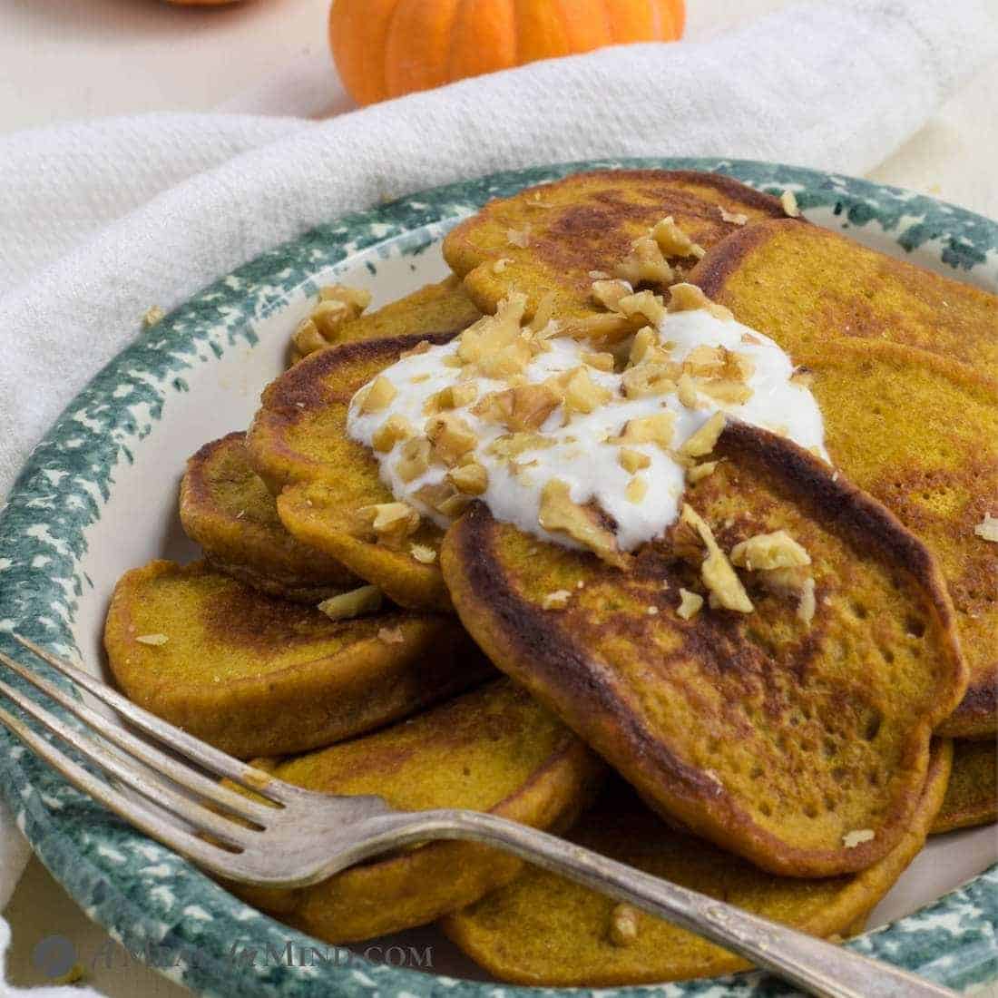 Pumpkin Protein Pancakes on ceramic platter with yogurt and walnuts