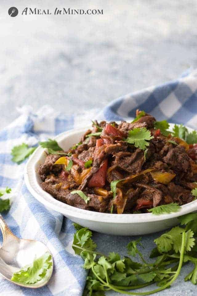 side view of Dutch oven carne asada in white bowl