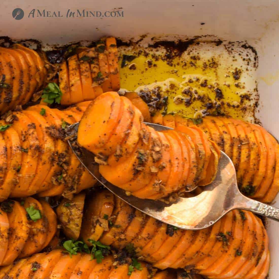 southwestern roasted sweet potatoes being served from roasting pan