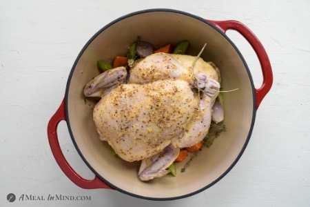 chicken brushed with lemon-mustard glaze on bed of vegetables in dutch oven