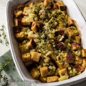 close up of herbed gluten-free stuffing in white baking dish