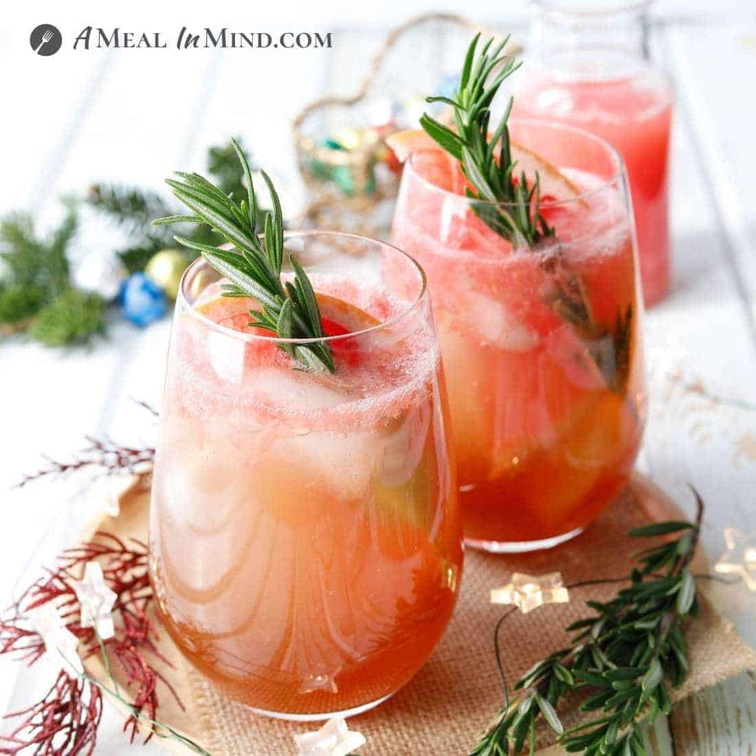 christmas-garnished paleo paloma mocktails with rosemary sprigs